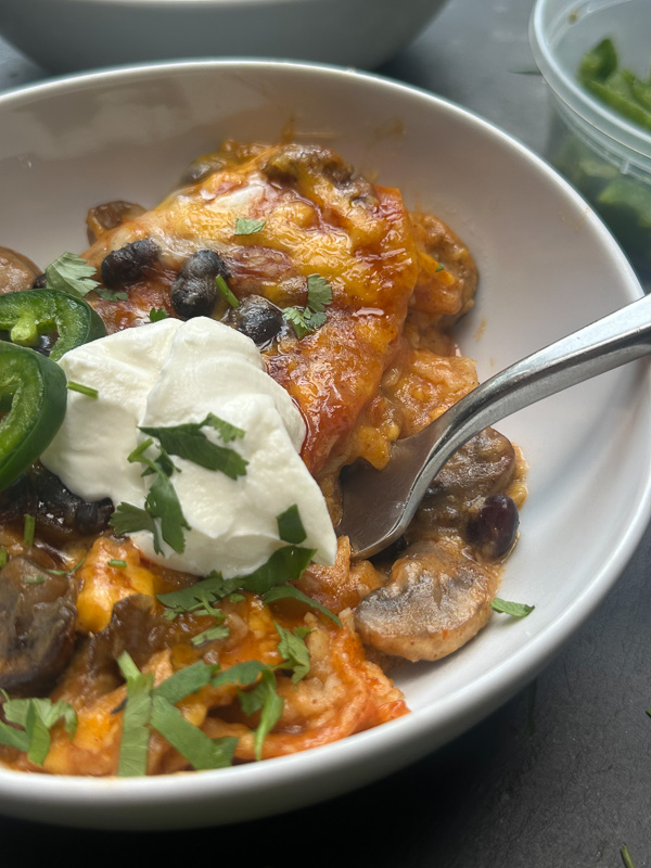 Looking for a delicious meatless meal? This Mushroom Enchilada Casserole is packed with savory mushrooms, cheesy goodness, and bold enchilada sauce. Perfect for weeknight dinners or meal prep! #VegetarianRecipe #EnchiladaCasserole #MushroomRecipes #EasyDinner #MeatlessMonday #Shutterbean