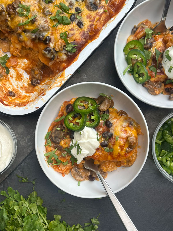 Looking for a delicious meatless meal? This Mushroom Enchilada Casserole is packed with savory mushrooms, cheesy goodness, and bold enchilada sauce. Perfect for weeknight dinners or meal prep! #VegetarianRecipe #EnchiladaCasserole #MushroomRecipes #EasyDinner #MeatlessMonday #Shutterbean