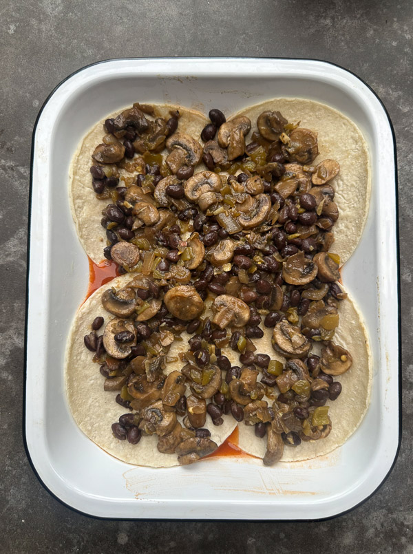 Looking for a delicious meatless meal? This Mushroom Enchilada Casserole is packed with savory mushrooms, cheesy goodness, and bold enchilada sauce. Perfect for weeknight dinners or meal prep! #VegetarianRecipe #EnchiladaCasserole #MushroomRecipes #EasyDinner #MeatlessMonday #Shutterbean