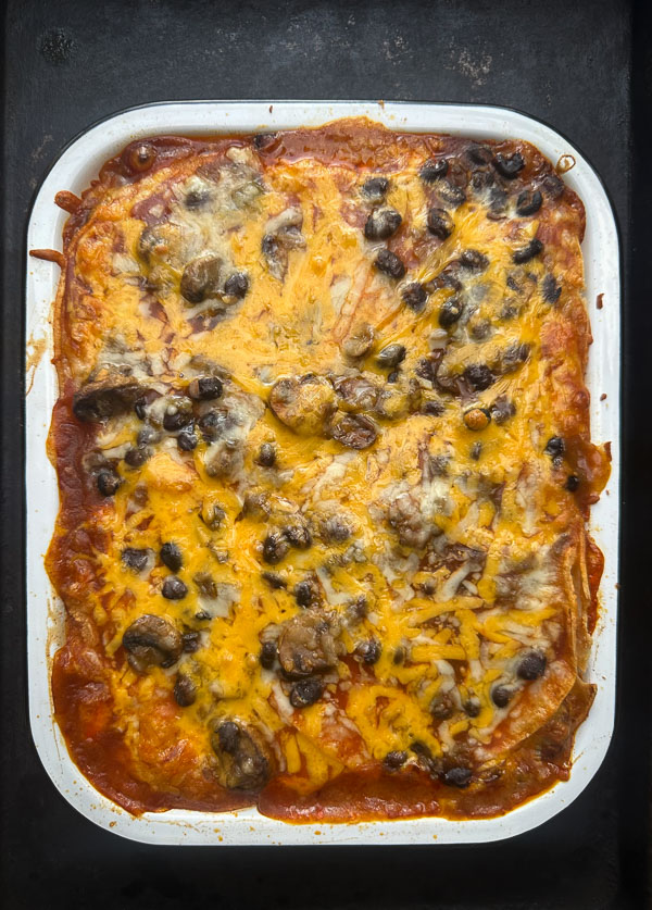 Looking for a delicious meatless meal? This Mushroom Enchilada Casserole is packed with savory mushrooms, cheesy goodness, and bold enchilada sauce. Perfect for weeknight dinners or meal prep! #VegetarianRecipe #EnchiladaCasserole #MushroomRecipes #EasyDinner #MeatlessMonday #Shutterbean